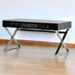 57" Black And Silver Wood And Stainless Steel Coffee Table With Three Drawers